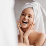 smiling woman with towel in her hair